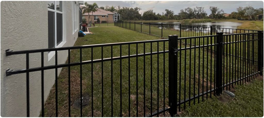 3-rail black aluminum fence showcasing front entryway